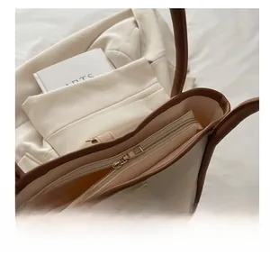 Detail view of smooth zipper closure and spacious yellow interior of tote bag