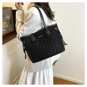 Detail of leopard print tote bag with drawstring accents and velvet texture on model