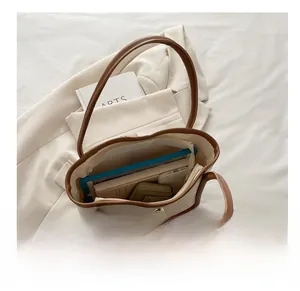 Top view of cream tote bag interior showing capacity for iPad, notebook, and wallet