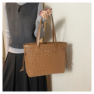 Close-up of leopard print tote bag featuring Creative Cat text and drawstring details