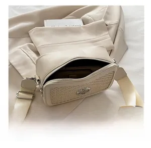 Top view of beige crossbody bag interior capacity with wallet and phone inside