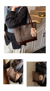 Macro shot of dark coffee faux leather tote with animal embossing and bear charm
