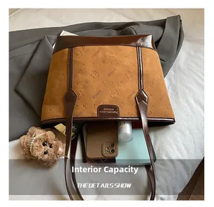 Spacious interior of tote bag showing storage for phone, tablet, and cosmetics
