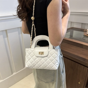 Elegant white quilted crossbody bag with gold chain strap and metal ball adjuster