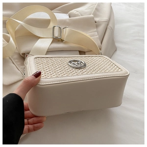 Detail of beige square shoulder bag with woven texture panel and silver metal M logo