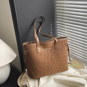 Leopard print tote bag in frosted suede with Creative Cat logo on a sunlit background