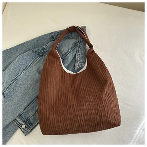 Close-up of brown pleated texture fabric on a large capacity casual tote bag