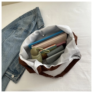 Top view of brown pleated tote bag interior showing large capacity for tablet and daily items