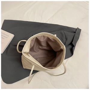Top view of cream white tote bag showing spacious brown fabric interior and zipper closure