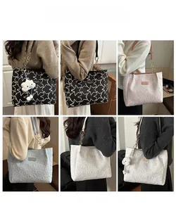 Detail of star-quilted tote bag with chain strap and plush cloud charm in various colors