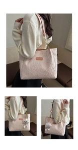 Detail of pink star-textured tote bag with chain strap and plush cloud charm accessory