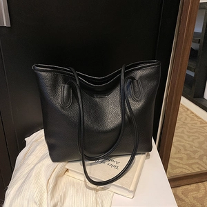 Classic black leather tote bag with pebble texture and slim shoulder straps for commuting