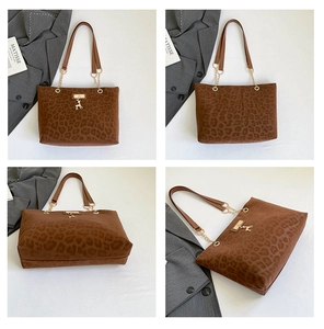 Detail view of leopard print tote bag with gold chain strap and metal charm pendant