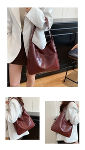Close-up of deep red tote bag with geometric stitching and large capacity design