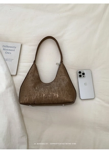 Brown leather crescent hobo bag detailing bottom studs and soft vintage texture