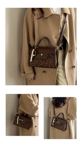 Detail of vintage crossbody bag with leopard print flap and beaded handle charm