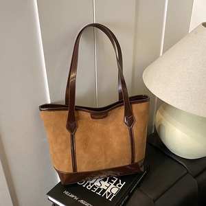 Retro brown tote bag featuring cartoon cat embossing and stylish dark leather trim
