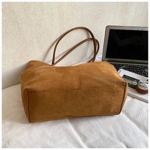 Brown suede tote bag shown with laptop and books for office and daily use