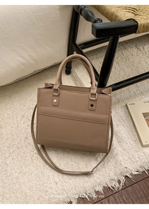 Detailed view of the light brown tote bag with premium lychee grain texture and handles