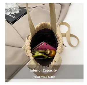 Internal view of beige canvas bucket bag showing storage space for sunglasses and wallet