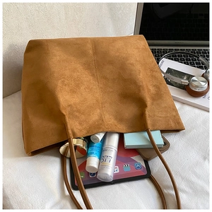 Brown suede tote bag interior showing large capacity for laptop and daily essentials
