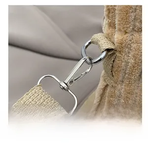 Detail of silver swivel hook and khaki corduroy fabric on a mini shoulder bag