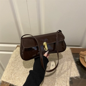 Deep brown glossy patent leather underarm bag with an elegant oval gold metal buckle