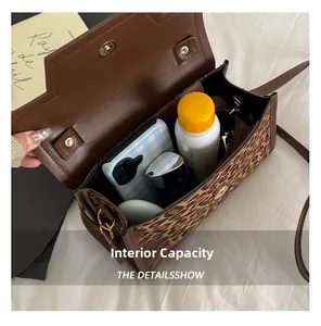 Internal capacity of leopard print shoulder bag showing space for phone and cosmetics