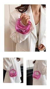 Detail of pink metallic translucent crescent bag with elegant gold chain strap and texture