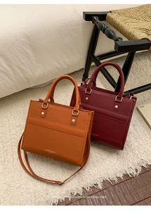 Close-up of litchi grain faux leather texture and metal rivet detail on stylish handbags