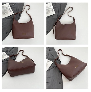 Macro view of dark coffee pebbled leather tote bag with elegant gold brand lettering