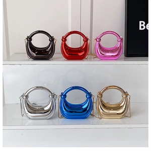 Glossy metallic evening bags in six colors arranged on a white tiered display stand