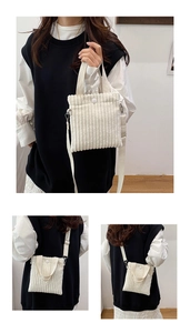 Detail of cream corduroy mini bag showing the vertical texture and detachable strap