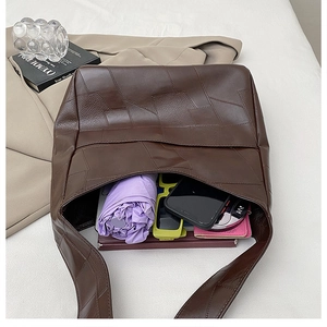 Interior view of deep brown tote bag showing large capacity for umbrella and phone