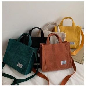 Detailed view of colorful corduroy tote bags with square patch and various strap options