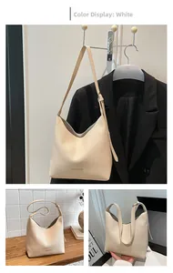 Detail of cream white lychee pattern handbag with adjustable strap and fashion logo