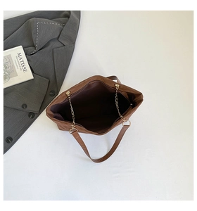 Top view of large brown tote bag showing spacious interior with leather and chain handles