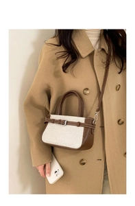 Detail view of retro patchwork crossbody bag in beige canvas and brown leather texture