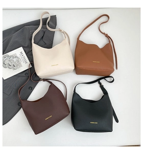 Detail of four colorful tote bags in lychee leather texture with gold foil logo
