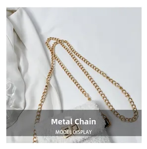 Detail of white plush shoulder bag featuring a gold metal chain and turn-lock closure