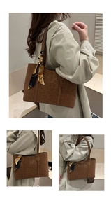 Close-up of brown leopard embossed tote bag with a decorative printed silk scarf handle