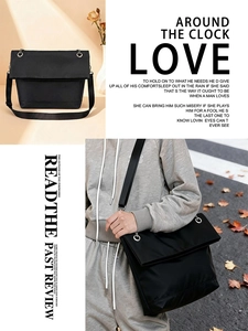 Detailed view of black nylon crossbody bag with flap closure and wide shoulder strap