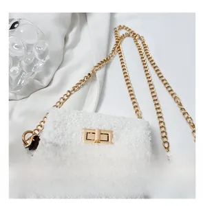 Detail of elegant gold metal twist lock and plush white faux fur texture on shoulder bag