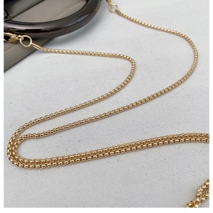 Macro detail of high-quality gold metal chain strap with polished lobster clasp and rings