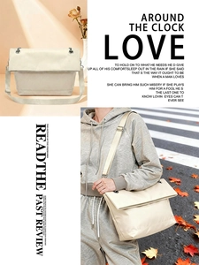 Detail of cream crossbody tote showing matte texture and silver eyelets with wide strap