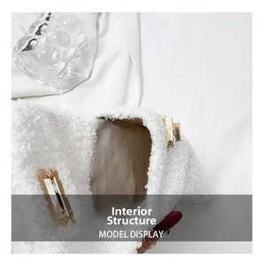 Internal structure of white plush handbag with golden clasp and herringbone lining