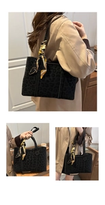 Detail of black leopard print tote bag with yellow silk scarf accessory for commute