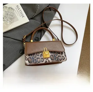 Detailed shot of retro leopard print patchwork bag with golden rectangular turn-lock