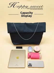Black nylon tote bag interior showing capacity for tablet, smartphone and makeup