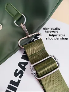 Detail of green nylon tote bag featuring premium silver metal buckle and adjustable strap